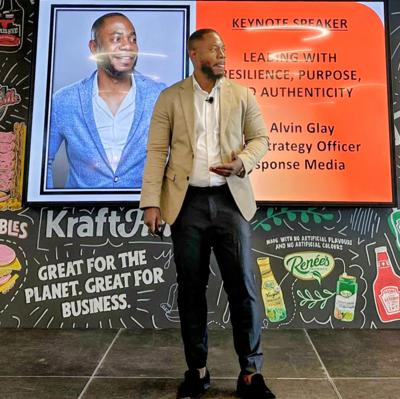 Dr. Glay presenting on stage at Kraft Heinz as keynote speaker